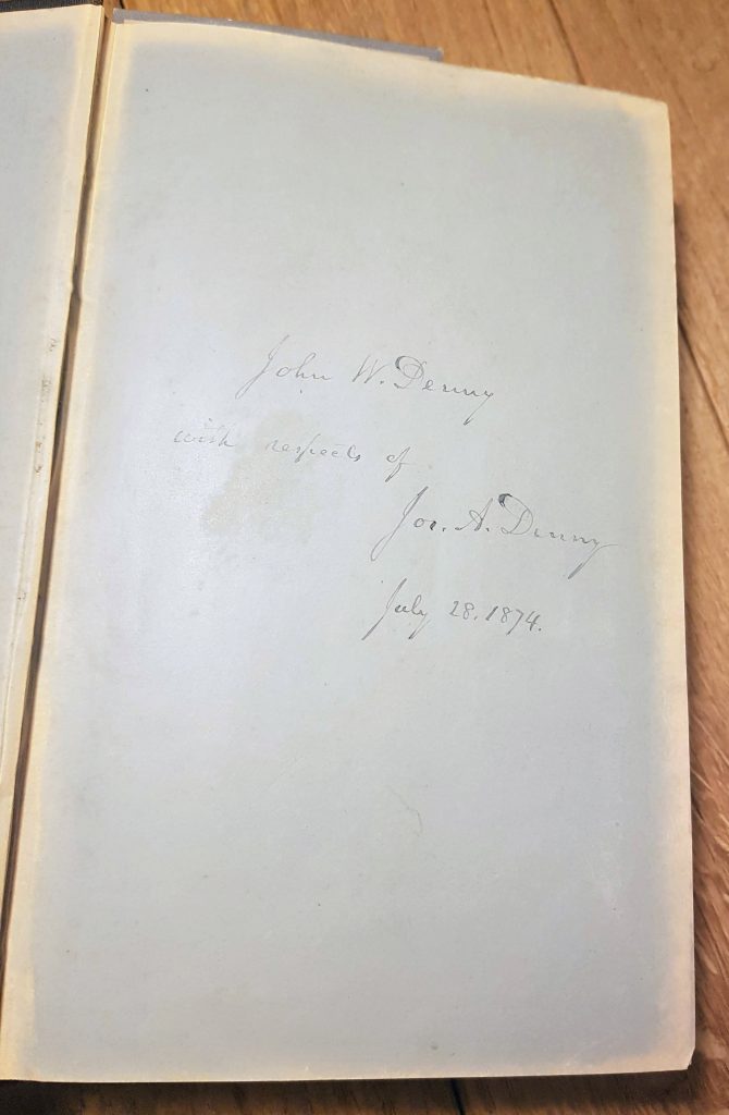 The flyleaf of a book, showing an inscription reading "John W Denny with respects of Jos A Denny, July 28 1874"