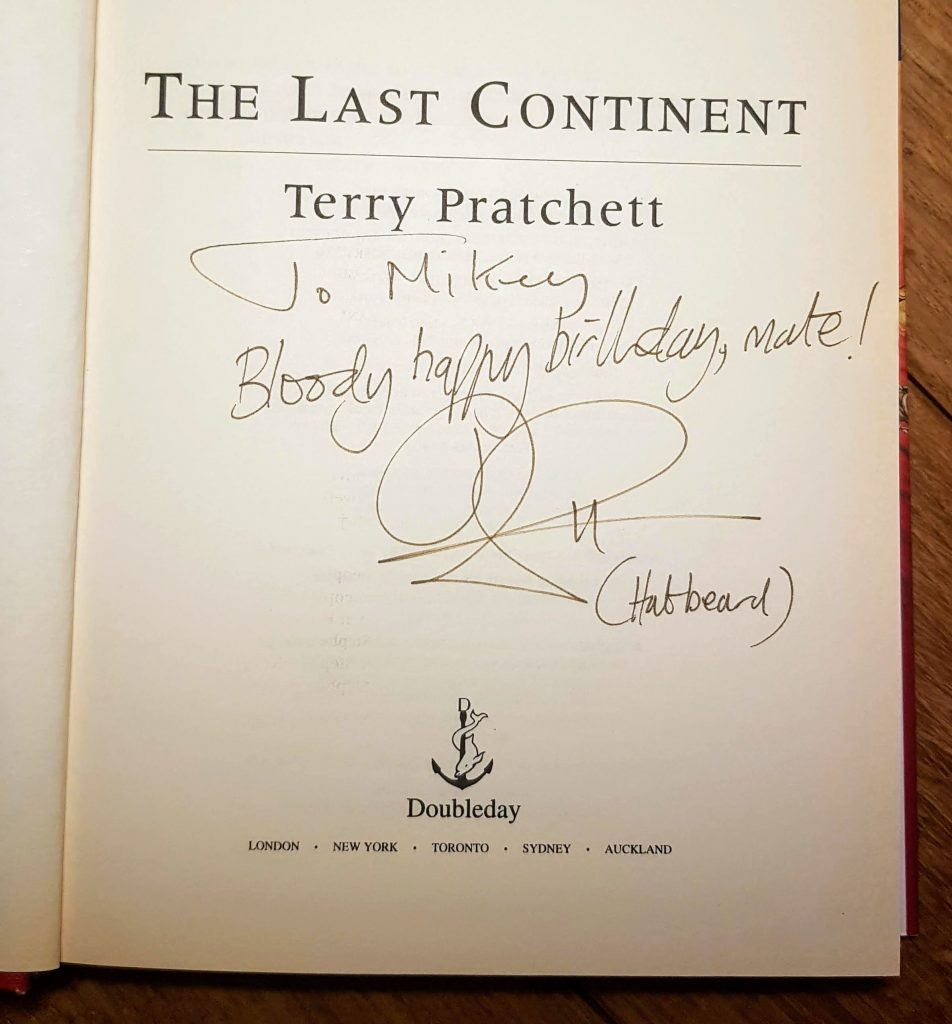 The title page of The Last Continent by Terry Pratchett. Inscription reads "To Mikey, Bloody Happy birthday, mate TP (hatbeard)"